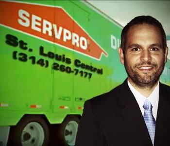 man in front of a SERVPRO trailer