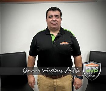 SERVPRO technician in front of SERVPRO office background